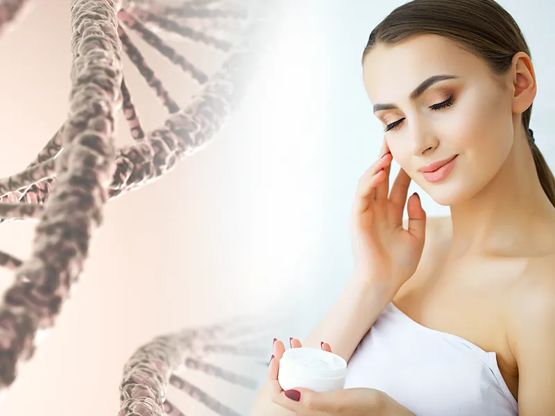 Woman applying DNA CryoStem cream to her face beside a DNA helix