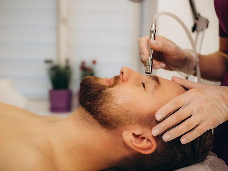 Microdermabrasion skin resurfacing treatment on the cheek