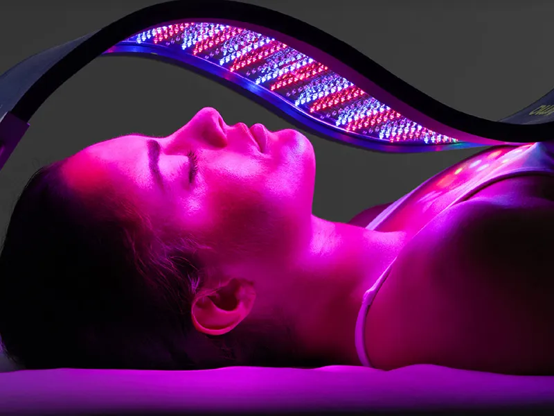Celluma LED light therapy panel over a guest's face